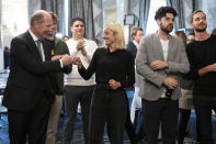 Laura Zimmermann, Co-President of Operation Libero, centre, together with Valentin Vogt, President of the Swiss Employers' Federation, Renato Perlini, campaign manager of Operation Libero, and Stefan Manser-Egli, Co-President of Operation Libero, from left, are pleased with the result of the vote at the meeting of opponents of the popular initiative "For moderate immigration" (restrictive initiative), on Sunday, Sept. 27, 2020 at the Hotel Schweizerhof in Bern, Switzerland. (Peter Klaunzer/Keystone via AP)