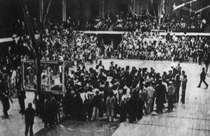 Black students stand quietly at center court of Rutgers University gym on Tuesday, Dec. 4, 1973, to protest what they called the University’s “institutional racism.”