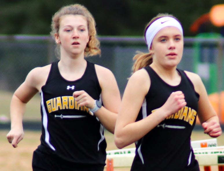 Emma O'Neil (left) and Jane Manthei of Petoskey St. Michael helped the Guardians qualify in the 3200 meter relay in first place.