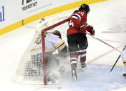 New Jersey Devils left wing Miles Wood (44) sends Boston Bruins goaltender Tuukka Rask (40) into the net during the first period of an NHL hockey game Thursday, Jan. 14, 2021, in Newark, N.J. Wood received a two-minute penalty for interference. (AP Photo/Bill Kostroun)