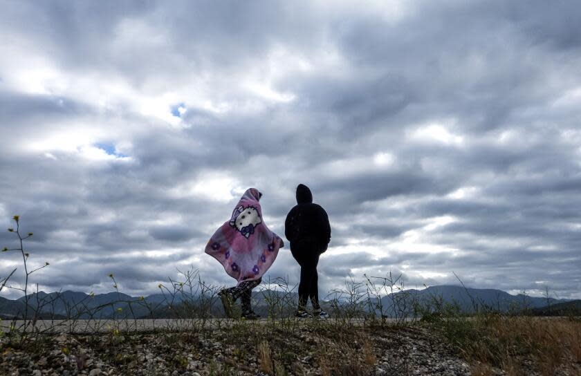 LAKE VIEW TERRACE, CA - APRIL 13: A blanket provides protection from the cold wind at the Hansen Dam bike path on Saturday, April 13, 2024 in Lake View Terrace, CA. Rain is expected for the Southland this weekend. (Myung J. Chun / Los Angeles Times)