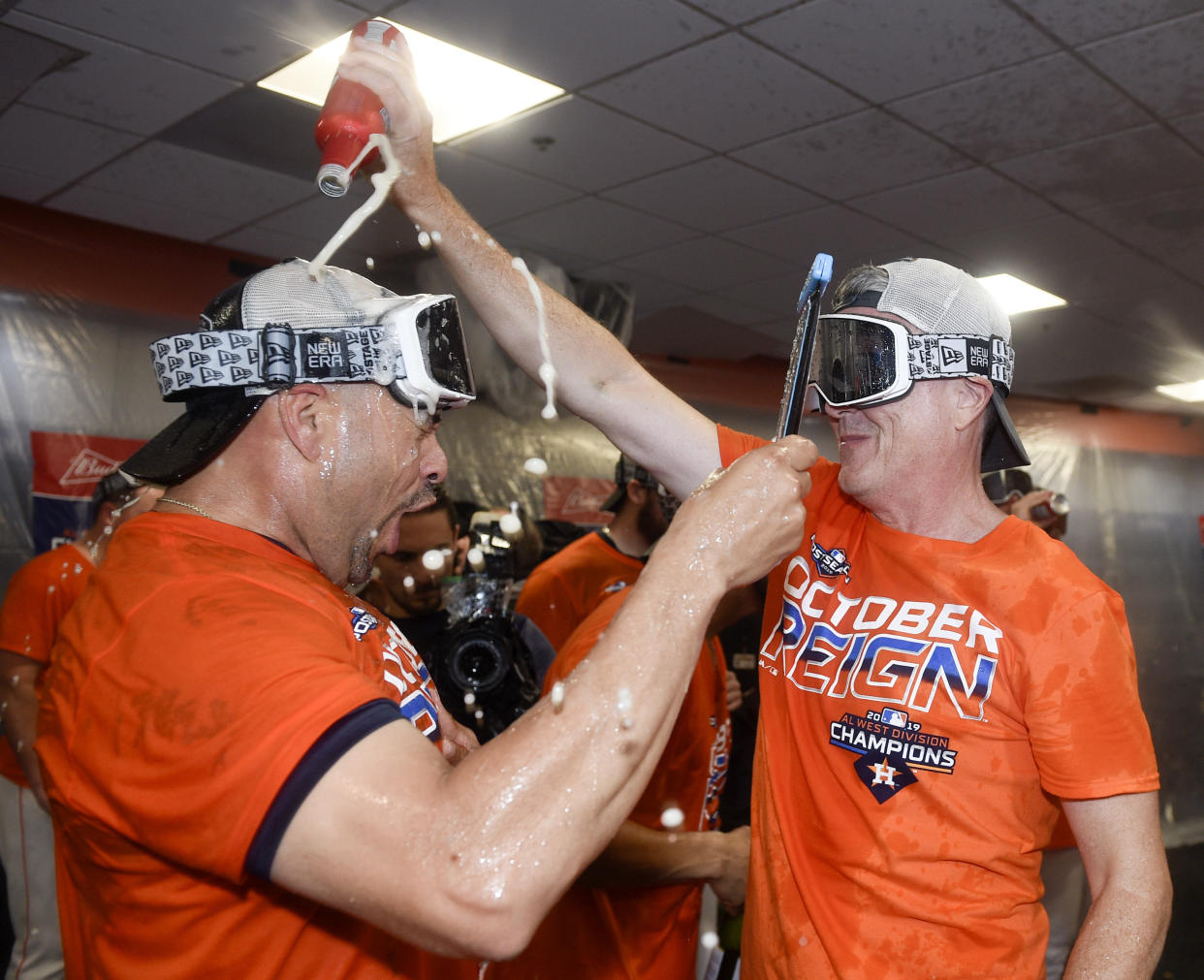 Houston Astros' general manager Jeff Luhnow, right, celebrates the team's clinching of the AL West crown with Javier Bracamonte after a baseball game against the Los Angeles Angels, Sunday, Sept. 22, 2019, in Houston. (AP Photo/Eric Christian Smith)