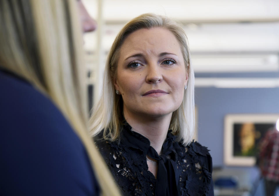 In this Saturday, March 23, 2019 photo, Columbine survivor Heather Martin reflects about the upcoming 20th anniversary of the mass shooting at her high school in suburban Denver. Martin helped found The Rebels Project, a support group for victims of mass shootings. Several survivors and family members of the Columbine victims gathered at the school's library to speak to the media Saturday, about the 1999 attack. (AP Photo/Thomas Peipert)