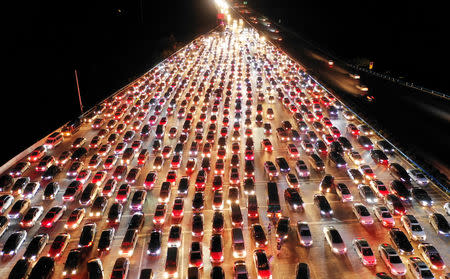 Vehicles are seen jammed on a express way near a toll station, at the end of the Mid-Autumn Festival holiday, in Zhengzhou, Henan province, China September 24, 2018. Picture taken September 24, 2018. REUTERS/Stringer