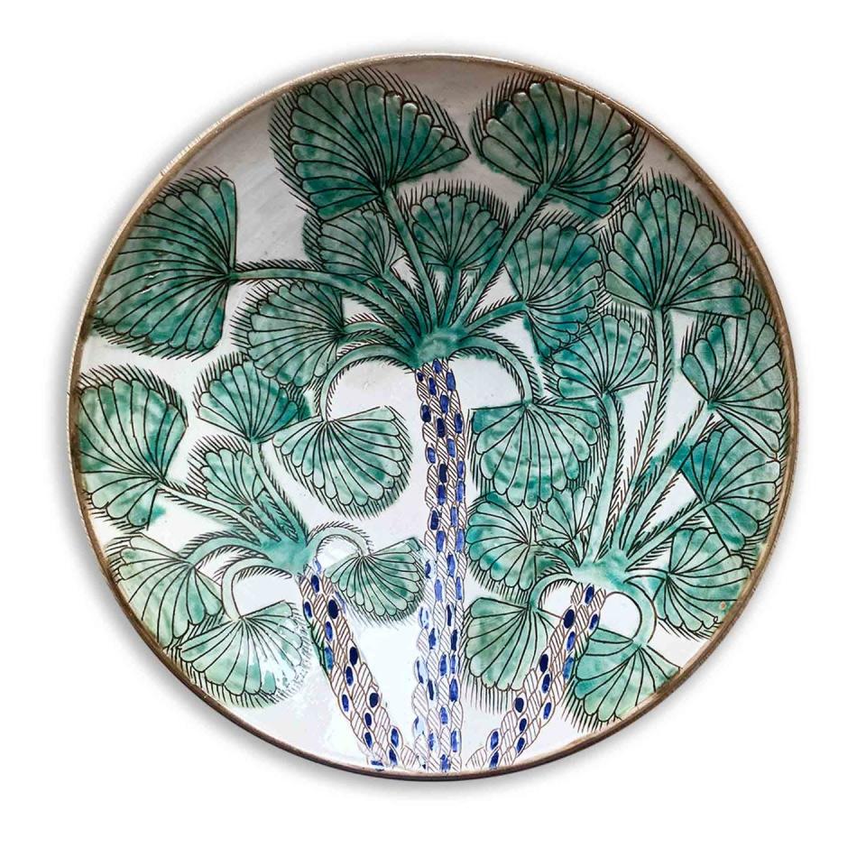 <p>The inspiration for the decoration on this glazed earthenware plate comes from the place it's made - the Oasis of Favoum in Egypt. Here, artisans have their studios next to their homes and make the plates by hand, meaning each is unique. £252, <a href="https://theinvisiblecollection.com/product/malaika-cluster-of-palms-serving-plate/" rel="nofollow noopener" target="_blank" data-ylk="slk:theinvisiblecollection.com" class="link ">theinvisiblecollection.com</a> <br></p>