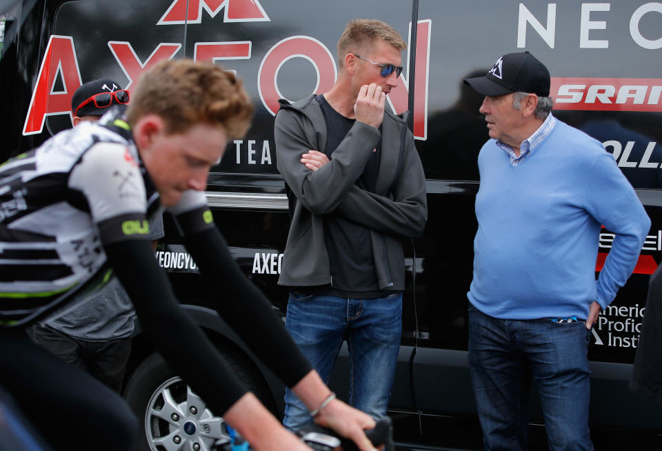 ONTARIO, CA - MAY 16:  Axel Merckx (C) director of the Axeon Cycling Team talks with his father Eddy Merckx (R) as Tao Geoghegan Hart (L) of Great Britain riding for Axeon Cycling warms up prior to the start of stage seven of the 2015 Amgen Tour of California from Ontario to Mt. Baldy on May 16, 2015 in Ontario, California.  (Photo by Doug Pensinger/Getty Images)