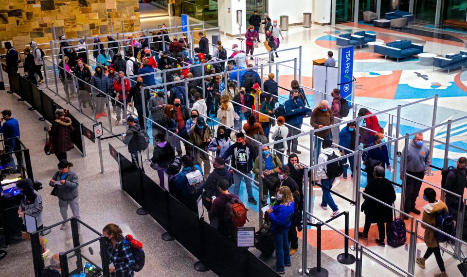 Travelers make their way though the security screening as they arrive for their flights out of Will Rogers World Airport in December.