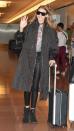 <p>In a Tommy x Gigi graphic sweater, dark trench coat, quilted leather leggings, suede booties, a studded wrap choker and futuristic Max Mara sunglasses while arriving in Tokyo. She packed up a leather backpack and a checkered luggage for the trip.</p>