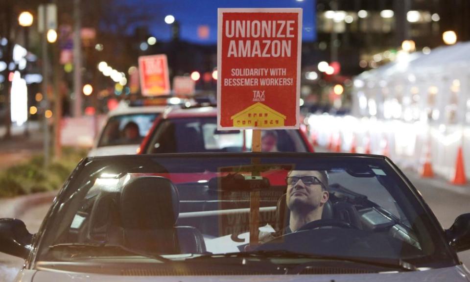 A man holds a sign in support of Amazon workers unionizing in Bessemer, Alabama, in Seattle, Washington, on 20 February.