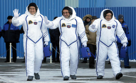 Members of the International Space Station expedition 54/55, Roscosmos cosmonaut Anton Shkaplerov (C), NASA astronaut Scott Tingle (R) and Norishige Kanai (L) of the Japan Aerospace Exploration Agency (JAXA) during the send-off ceremony after checking their space suits before the launch of the Soyuz MS-07 spacecraft at the Baikonur cosmodrome, in Kazakhstan, 17 December 2017. REUTERS//Maxim Shipenkov/Pool