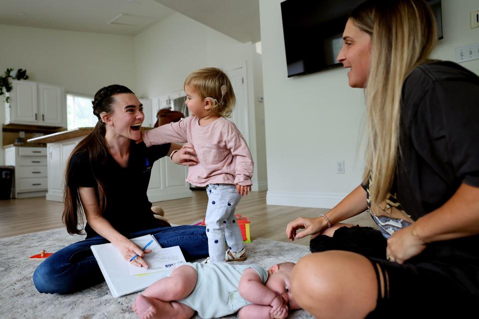 Emilee Segura teases and is teased by Lucy Bentley during a session, Lucy’s mother Megan Bentley helps also in Orem on Wednesday, Sept. 13, 2023. Emilee was born deaf and received her first cochlear implant at just 18-months-old thanks to newborn screening and follow-up care. Her parents were able to intervene early, which prevented significant delays in Emilee’s speech, language and emotional development. | Scott G Winterton, Deseret News