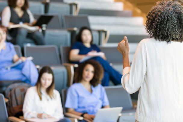 STOCK PHOTO: A teacher gestures as she lectures a class of college students. (STOCK PHOTO/Getty Images)