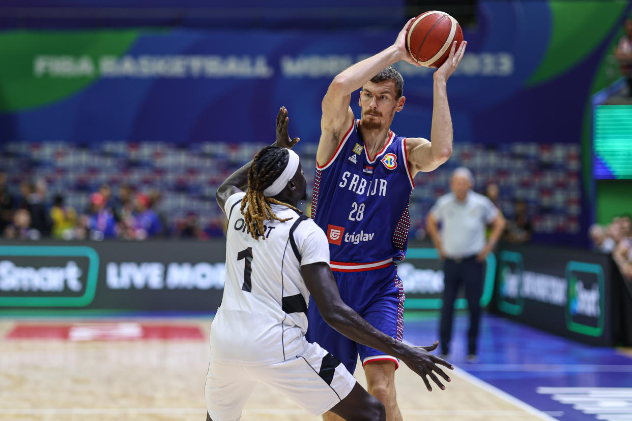 MANILA, PHILIPPINES - AUGUST 30: Borisa Simanic #28 of Serbia drives the ball against Nuni Omot #1 of South Sudan during the first round Group B match between South Sudan and Serbia on day 6 of the FIBA Basketball World Cup at Araneta Coliseum on August 30, 2023 in Manila, Philippines. (Photo by Liu Lu/VCG via Getty Images)
