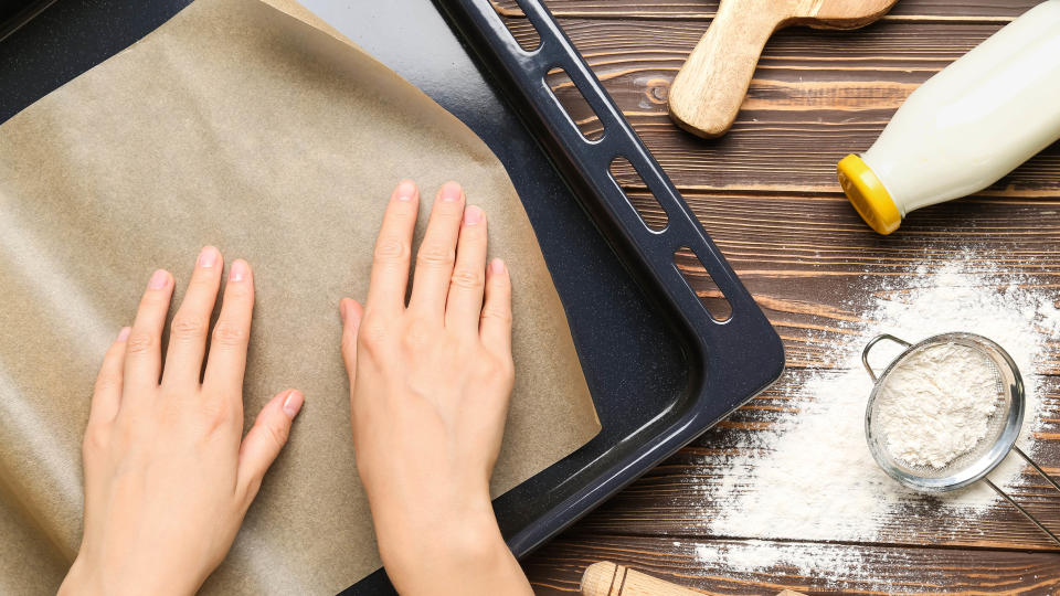 Baking parchment being placed on a tray