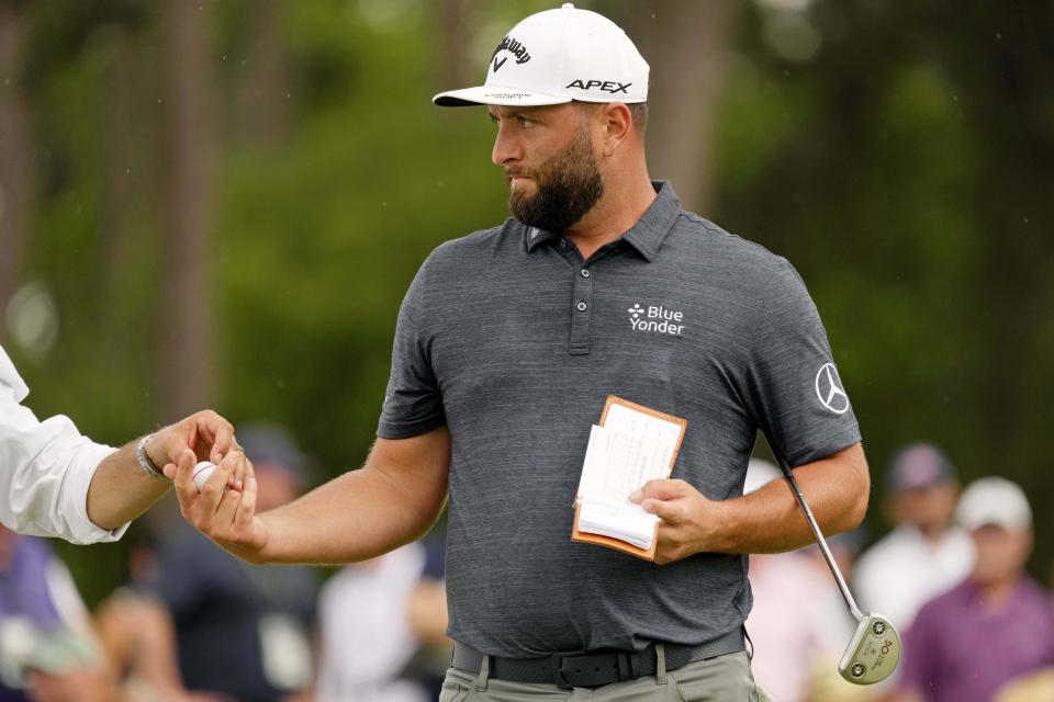 Jon Rahm gets his golf ball before making a final birdie on No. 18 on Thursday in Round 1 of the Masters Tournament.