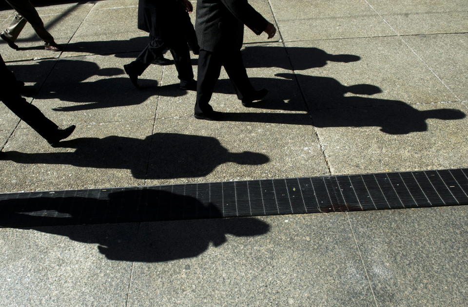 Workers cast shadows as they walk in Toronto's financial district on Monday, Feb. 27, 2012. A survey of Canadian employers by one of Ontario’s largest pension providers found that among their top concerns are employee burnout, high turnover, and the ongoing labour shortage.THE CANADIAN PRESS/Nathan Denette