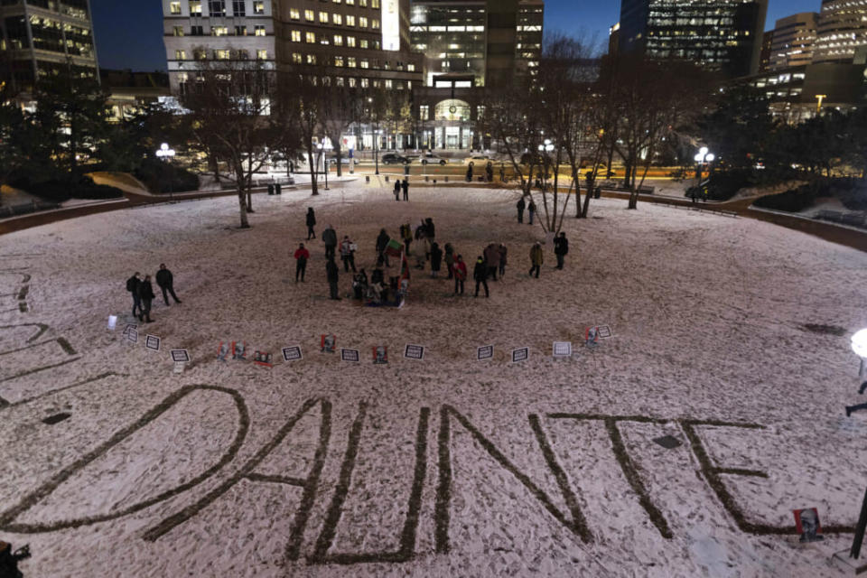 Protesters write Daunte Wright’s name in the snow on the third day of jury deliberation outside of the Hennepin County Government Center on Wednesday, Dec. 22, 2021, in Minneapolis. Former Minneapolis police officer Kim Potter, who is white, is charged with first- and second-degree manslaughter in the shooting of Wright, a Black motorist, in the suburb of Brooklyn Center. Potter has said she meant to use her Taser – but grabbed her handgun instead – after Wright tried to drive away as officers were arresting him. (AP Photo/Christian Monterrosa)