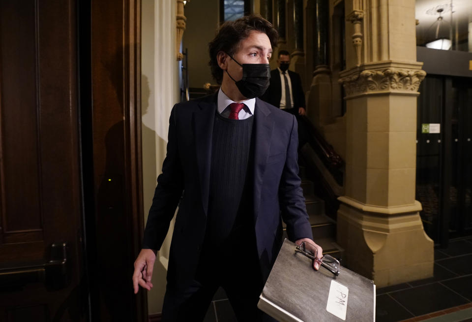 Canadian Prime Minister Justin Trudeau stops to speak with the media as he makes his way to caucus, Wednesday, Dec. 8, 2021 in Ottawa, Ontario. (Adrian Wyld/The Canadian Press via AP)