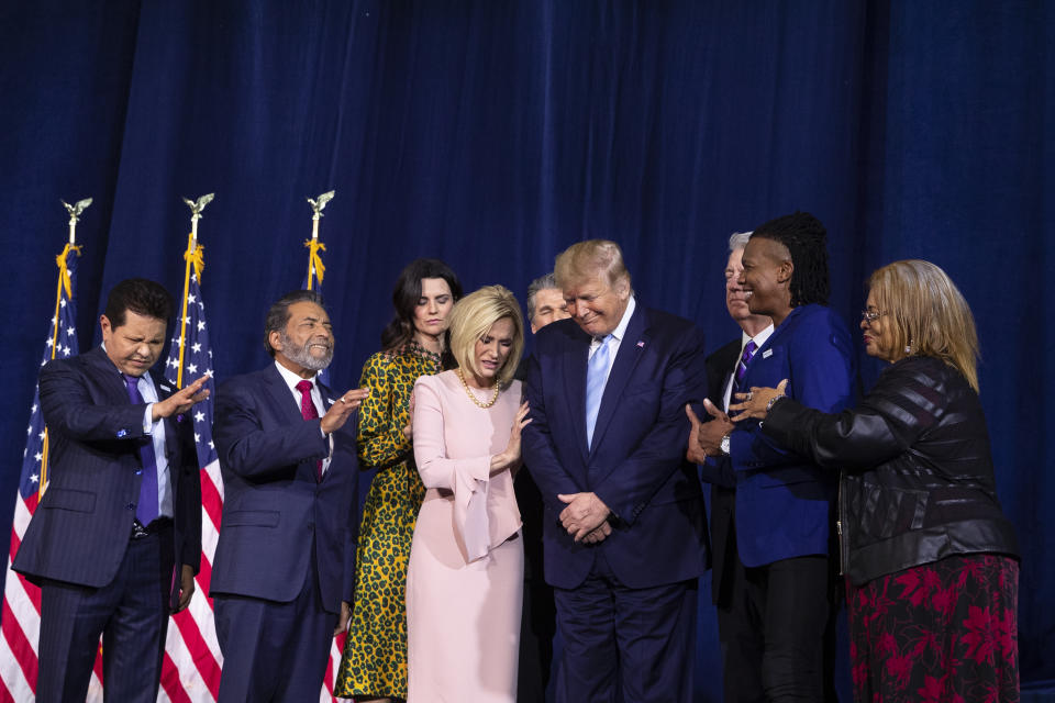 FILE - In this Jan. 3, 2020 file photo, faith leaders pray over President Donald Trump during an "Evangelicals for Trump Coalition Launch" at King Jesus International Ministry in Miami. On Sunday, Jan. 10, 2021, the first day of Christian worship services since the Capitol riot, religious leaders who have supported the president in the past delivered messages ranging from no mention of the events of that day to incendiary recitations of debunked conspiracy theories. (AP Photo/Evan Vucci, File)