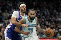 Charlotte Hornets forward Cody Martin drives to the basket past Philadelphia 76ers guard Seth Curry during the first half of an NBA basketball game on Monday, Dec. 6, 2021, in Charlotte, N.C. (AP Photo/Chris Carlson)