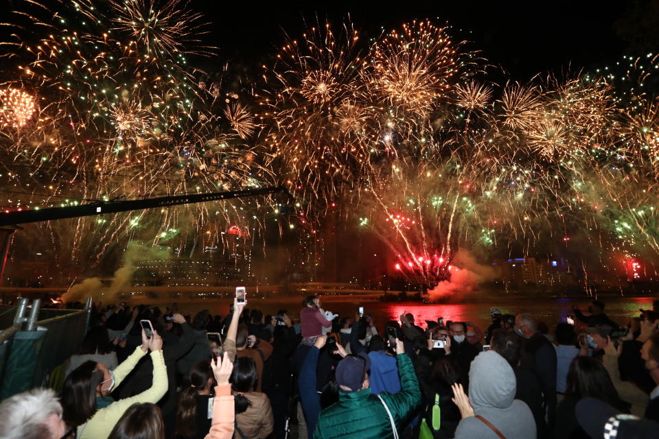 People celebrate in Brisbane, Australia, Wednesday, July 21, 2021, following an announcement by the International Olympic Committee that Brisbane was picked to host the 2032 Olympics. The Australian city was the inevitable winner of a one-candidate race steered by the IOC to avoid rival bids. (Jason O'Brien/AAP Image via AP)