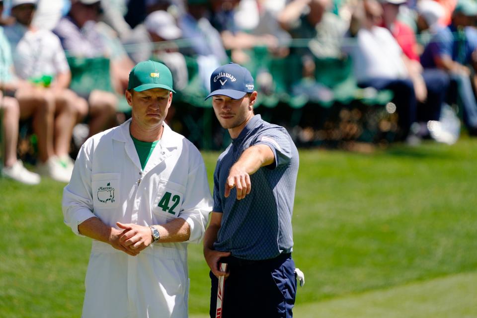 Apr 12, 2024; Augusta, Georgia, USA; Nicolai Hojgaard consults with his caddie Christian Christensen
on the No. 16 green during the second round of the Masters Tournament. Mandatory Credit: Katie Goodale-USA TODAY Network