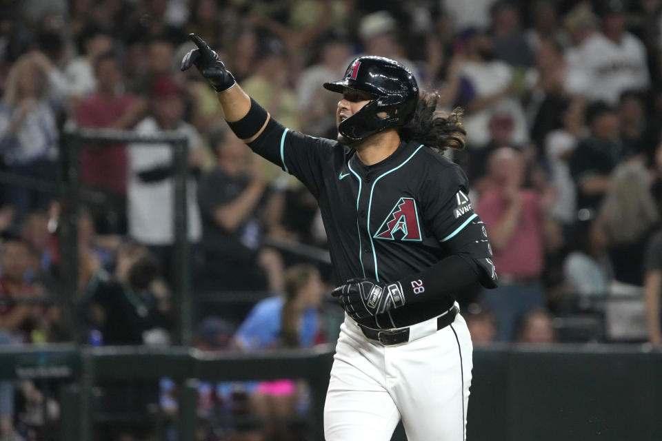 Arizona Diamondbacks' Eugenio Suarez reacts after hitting a solo home run against the Colorado Rockies in the fourth inning during a baseball game, Saturday, March 30, 2024, in Phoenix. (AP Photo/Rick Scuteri)