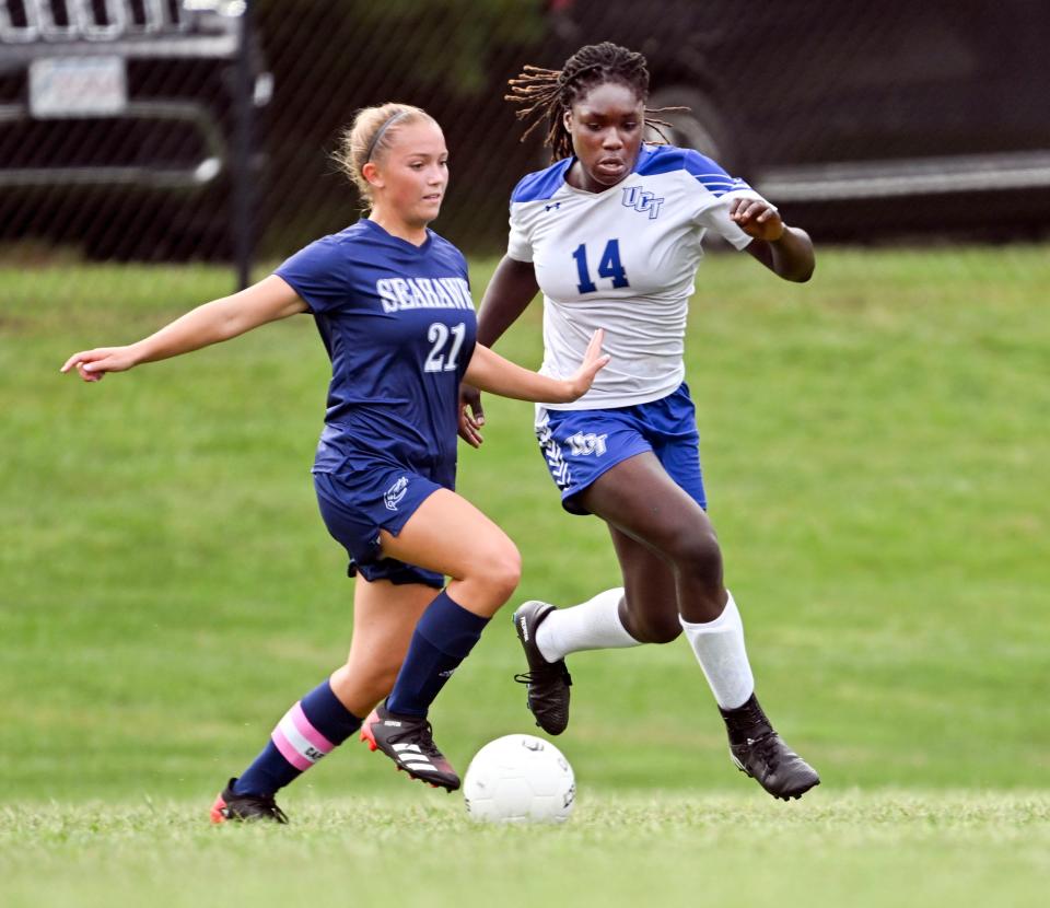Alaina Hines of Upper Cape Tech runs with Taylor Bodurtha of Cape Cod Academy for the ball.