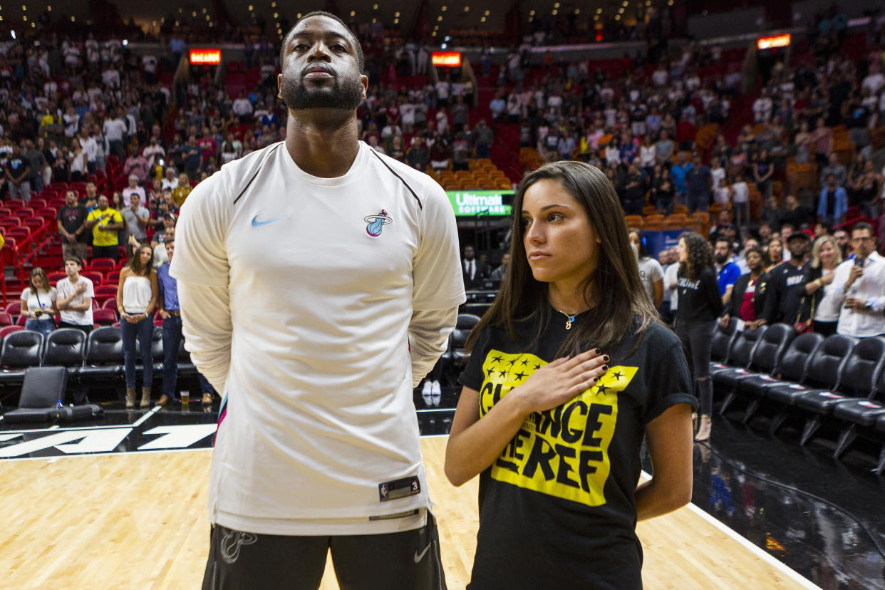 The Miami Heat's Dwyane Wade stands next to Andrea Ghersi, the sister of Joaquin Oliver, 17, who was killed in the Marjory Stoneman Douglas High School shooting, during the singing of the national anthem before the Heat faced the Detroit Pistons at the AmericanAirlines Arena in Miami on Saturday, March 3, 2018. (Matias J. Ocner/Miami Herald/TNS via Getty Images)