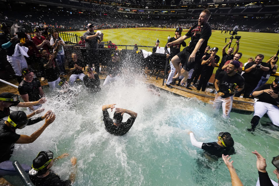 The Arizona Diamondbacks celebrate in the Chase Field pool after clinching a Wild Card spot in the MLB playoffs after a baseball game against the Houston Astros Saturday, Sept. 30, 2023, in Phoenix. The Astros won 1-0. (AP Photo/Ross D. Franklin)