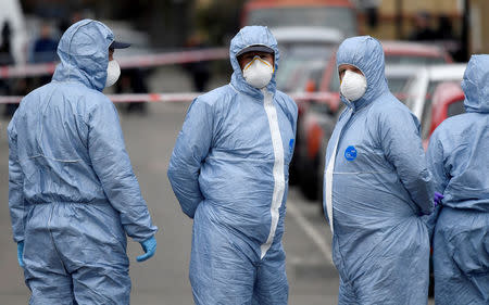 Forensic investigators stand in the middle of the road on Chalgrove Road, where a teenage girl was murdered, in Tottenham, Britain, April 3, 2018. REUTERS/Toby Melville