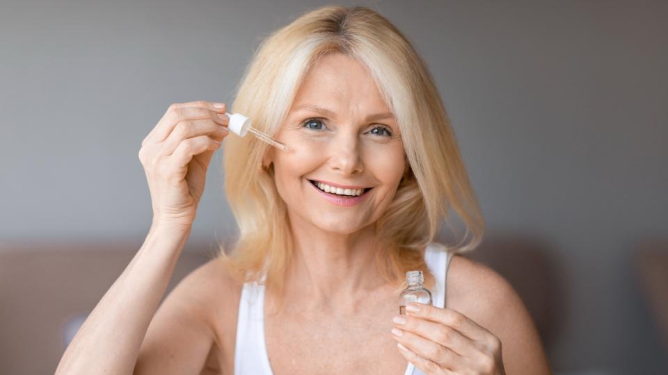 Mature woman using collagen serum