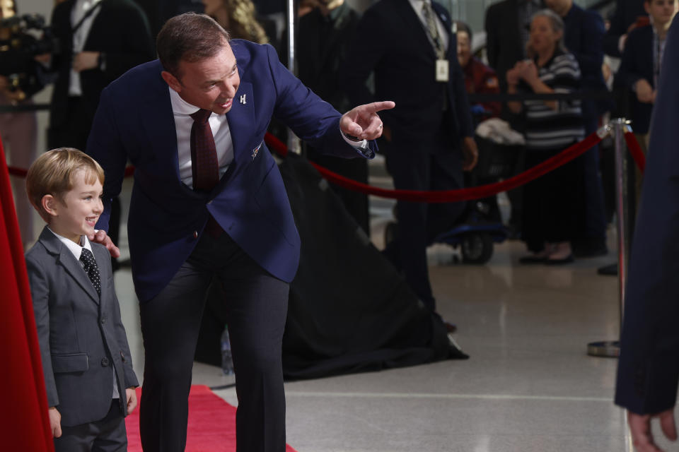 Chad Knaus stands with his son Kipling Knaus as they arrive for his induction into the NASCAR Hall of Fame in Charlotte, N.C., Friday, Jan. 19, 2024. (AP Photo/Nell Redmond)