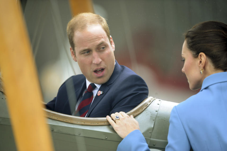 Britain's Prince William sitting in a classic Sopwith Pup chats with his wife Kate, the Duchess of Cambridge as they tour the Omaka Aviation Heritage Centre in Blenheim, New Zealand, Thursday, April 10, 2014. (AP Photo/SNPA, Ross Setford) NEW ZEALAND OUT