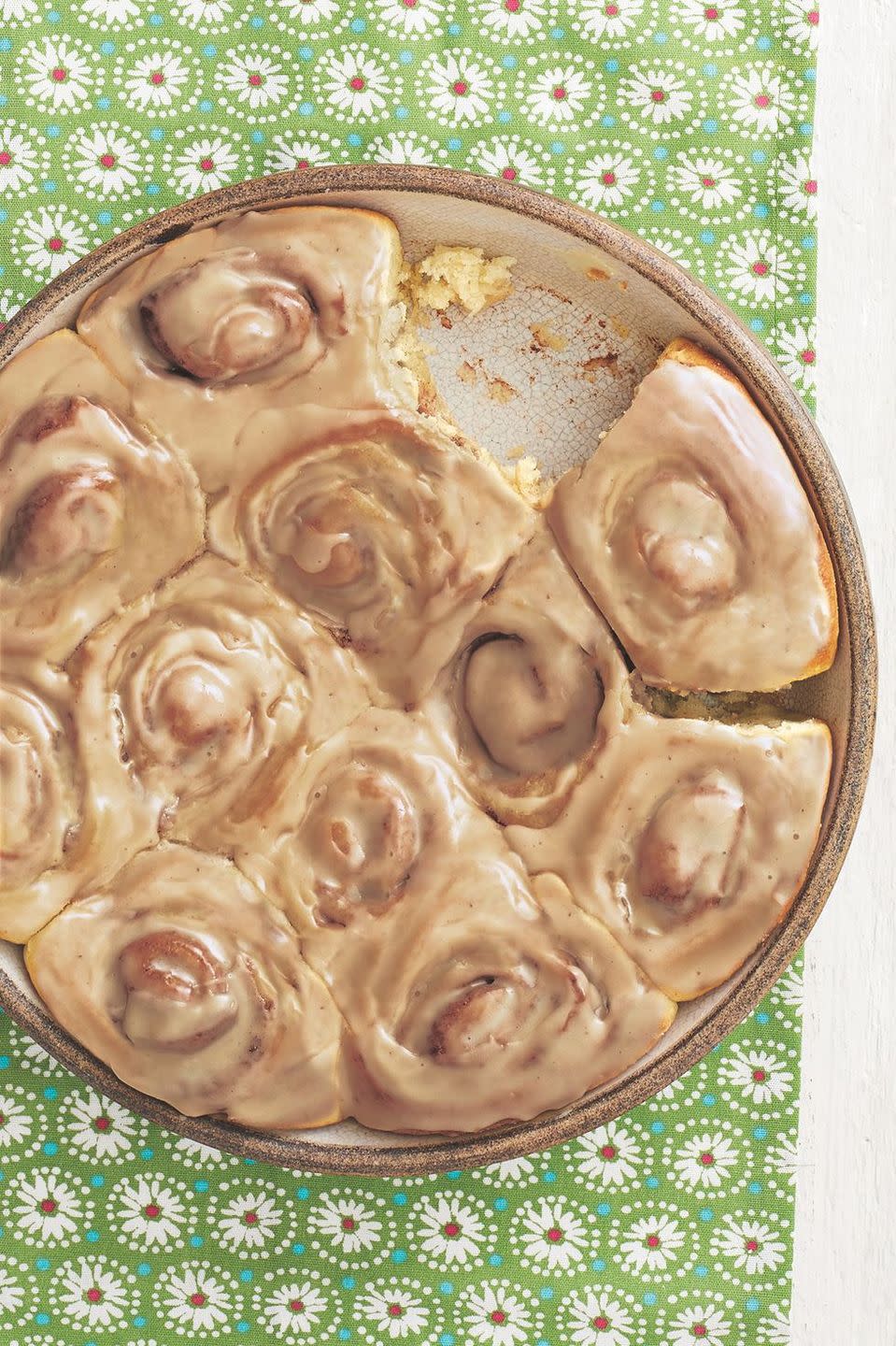 cinnamon rolls in round dish on green linen