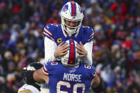 Buffalo Bills quarterback Josh Allen (17) celebrates with center Mitch Morse (60) after throwing a touchdown pass against the Pittsburgh Steelers during the first quarter of an NFL wild-card playoff football game, Monday, Jan. 15, 2024, in Buffalo, N.Y. (AP Photo/Jeffrey T. Barnes)