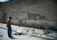 A man looks at the site where a truck plowed into a crowd of pilgrims in Mazapil, Zacatecas State on July 30, 2015