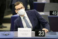 Poland's Prime Minister Mateusz Morawiecki sits Tuesday, Oct. 19, 2021 at the European Parliament in Strasbourg, eastern France. The European Union's top official locked horns Tuesday with Poland's prime minister, arguing that a recent ruling from the country's constitutional court challenging the supremacy of EU laws is a threat to the bloc's foundations and won't be left unanswered. (Ronald Wittek, Pool Photo via AP)