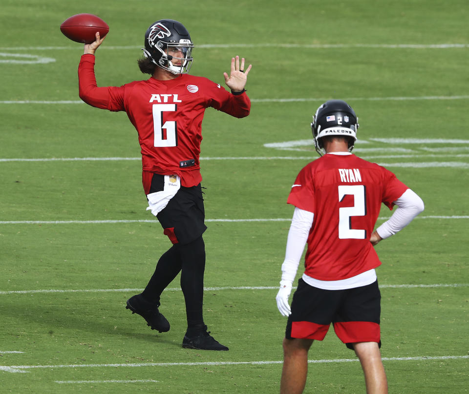 Atlanta Falcons backup quarterback Kurt Benkert completes a pass with Matt Ryan looking on during NFL football training camp practice Saturday, Aug. 15, 2020, in Flowery Branch, Ga. (Curtis Compton/Atlanta Journal-Constitution via AP)