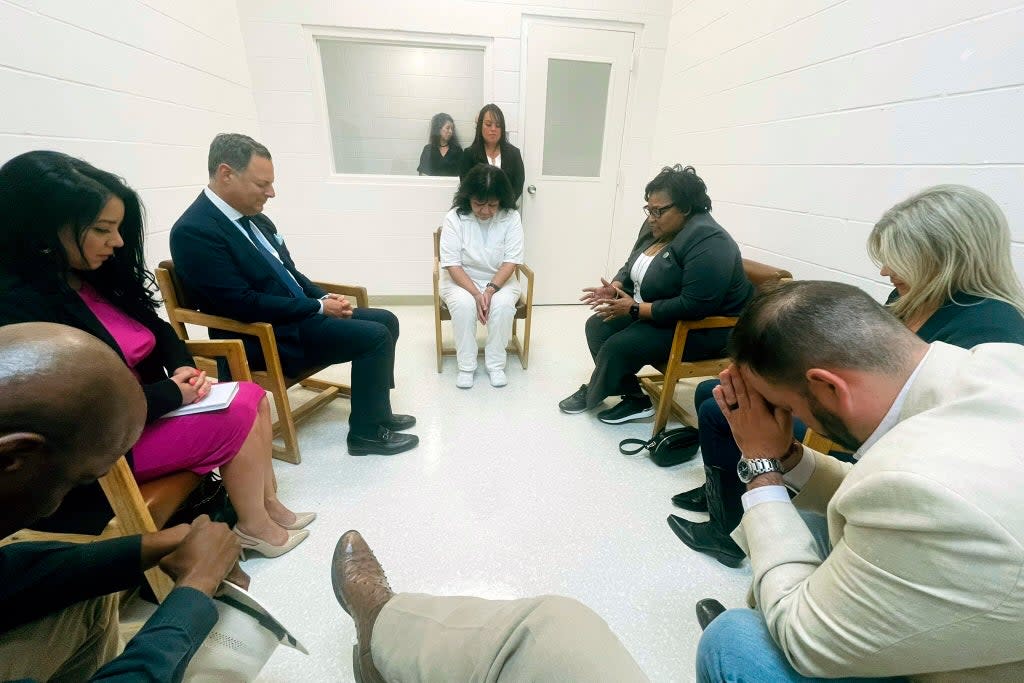 Melissa Lucio praying with Texas state lawmakers on death row before she was granted a stay of execution   (AP)