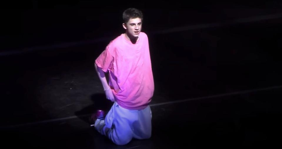 A young Timothée Chalamet dances during a school performance.