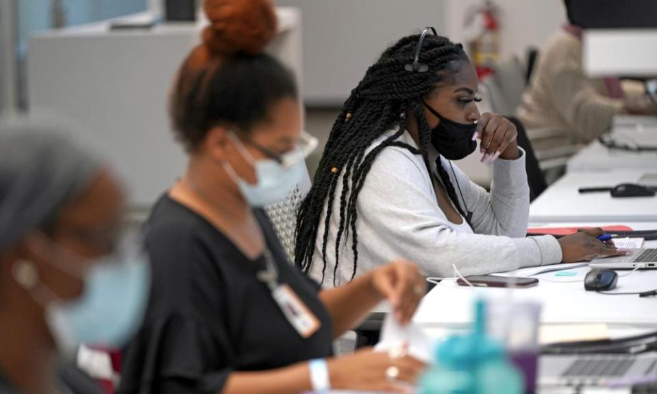 Contact tracer Kandice Childress, right, works at Harris county public health contact tracing facility, 25 June 2020, in Houston.