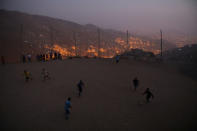 Men play soccer at a makeshift soccer field in Nueva Union shantytown in Villa Maria del Triunfo district of Lima, Peru, May 27, 2018. REUTERS/Mariana Bazo