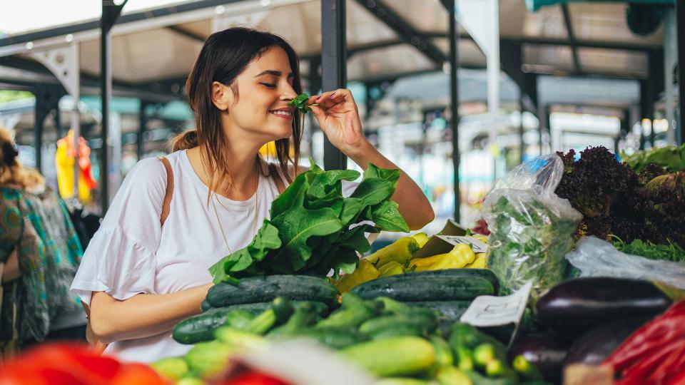 Young cheerful woman at the market.