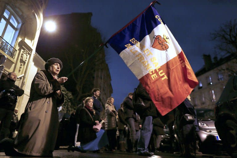 A woman holds a French flag during a protest organized by fundamentalist Christians group Civitas Institute against same-sex marriage on January 29, 2013 in Paris. France's prime minister on Tuesday predicted that gay marriage will quickly be accepted by a country that has spent months embroiled in rancorous debate