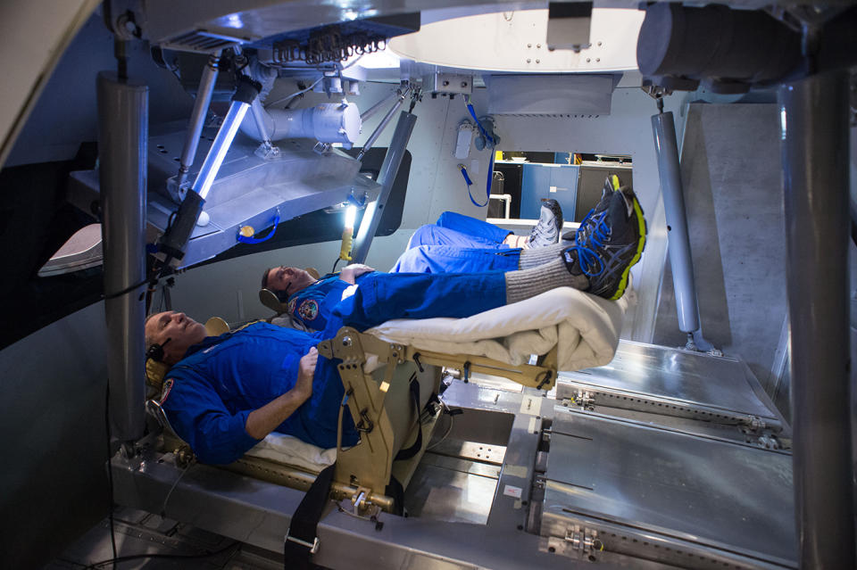 Astronauts practice a launch in an Orion capsule mockup to provide feedback on the cockpit's new instrumentation and control layout.
