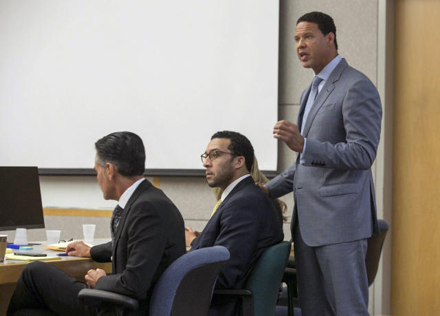 Brian Watkins, right, an attorney for former NFL football player Kellen Winslow II, puts his hands on Winslow as he gives his opening statement to the jury during Winslow's rape trial. (AP)