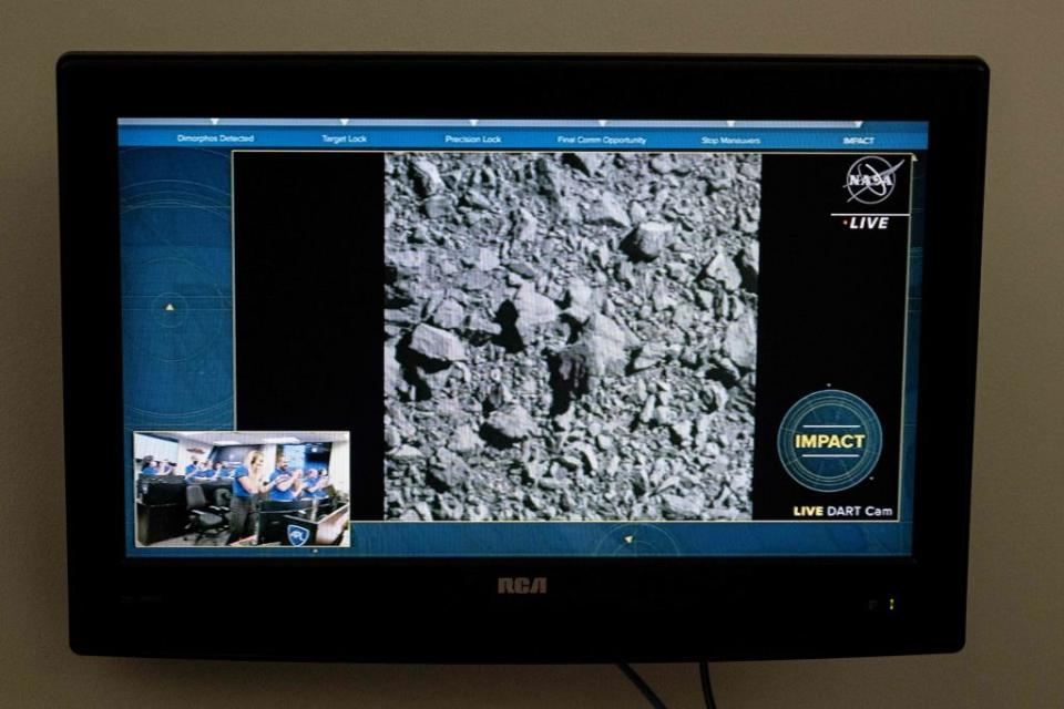 A television at NASA's Kennedy Space Center in Cape Canaveral, Florida, captures the final images from the Double Asteroid Redirection Test (DART) as it smashes into the asteroid Dimorphos on Sept. 26, 2022.<span class="copyright">JIM WATSON/AFP—Getty Images</span>