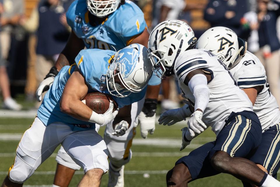 Kent State running back Gavin Garcia slams into Akron defensive back KJ Martin on a rushing play during their Oct. 22 game at Dix Stadium.