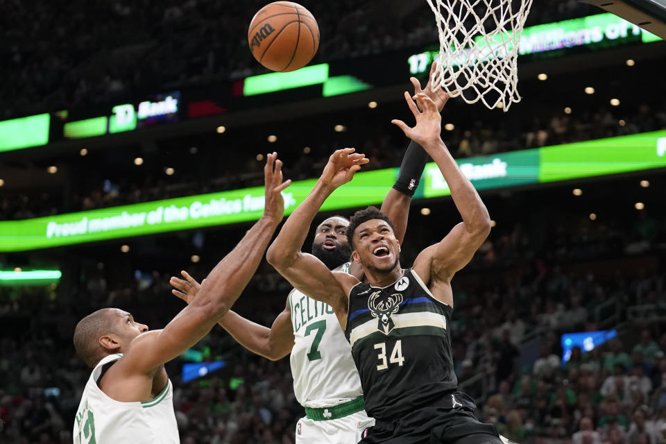 Boston Celtics center Al Horford, left, and guard Jaylen Brown, center, vie for a rebound with Milwaukee Bucks forward Giannis Antetokounmpo, right, during the first half of Game 7 of an NBA basketball Eastern Conference semifinals playoff series, Sunday, May 15, 2022, in Boston. (AP Photo/Steven Senne)